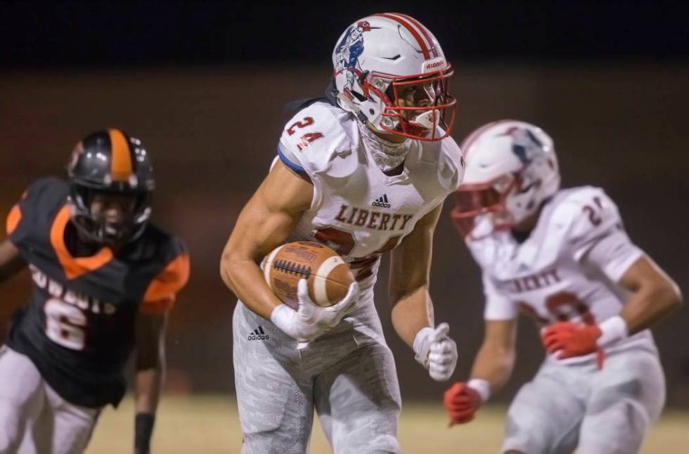 Liberty senior safety Lehi Ausage (24) returns an interception for a touchdown past Chaparral s ...