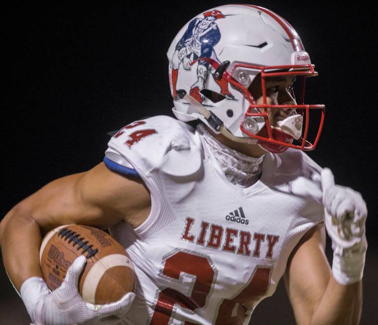 Liberty senior safety Lehi Ausage (24) returns an interception for a touchdown in the first qua ...