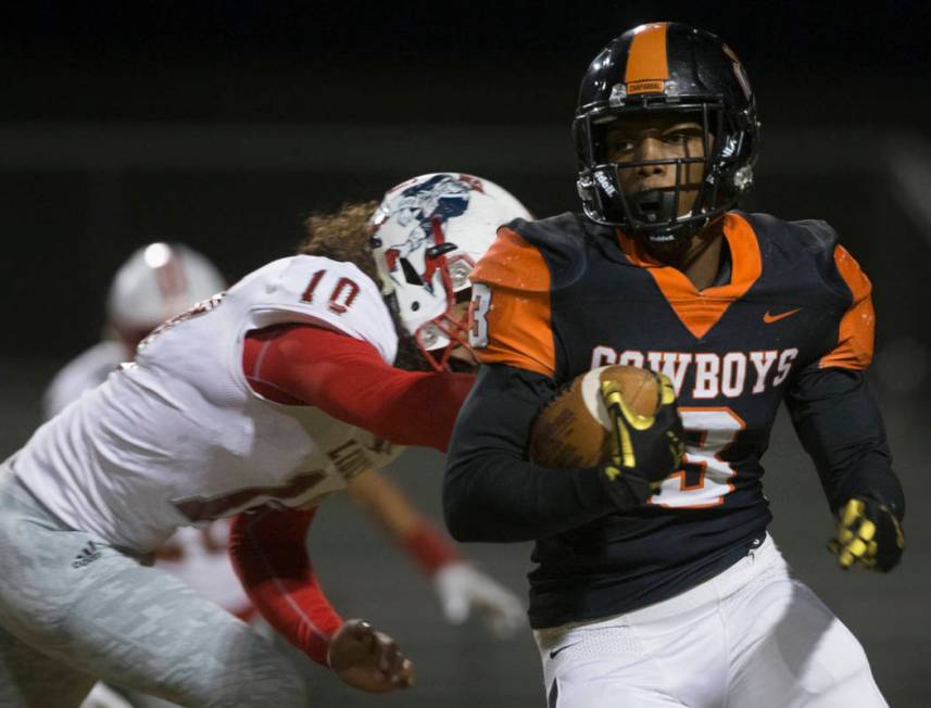 Chaparral senior running back Meshach Hawkins (3) turns the corner past Liberty senior lineback ...