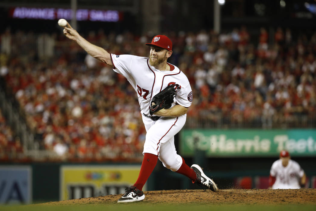 Washington Nationals relief pitcher Stephen Strasburg throws to the Milwaukee Brewers in the si ...