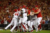 Members of the Washington Nationals celebrate after winning a National League wild-card basebal ...
