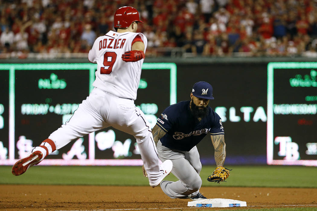 Milwaukee Brewers first baseman Eric Thames, right, reaches but is unable to make the tag on ti ...