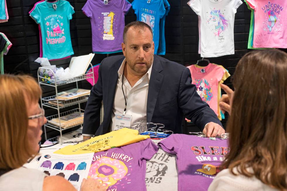 Darin Lefkowitz, CEO of JK2, a company that sells kids apparel, talks to customers Sheila Wewer ...