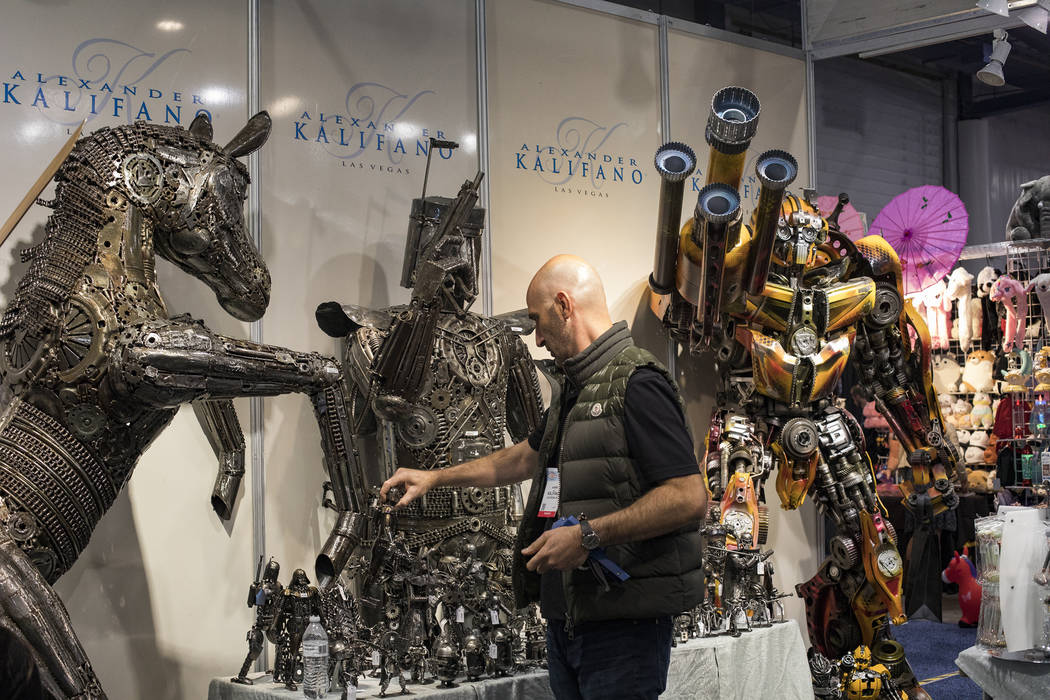 Alex Kalifano rearranges metal sculptures at his booth at the Souvenir & Resort Gift Show a ...