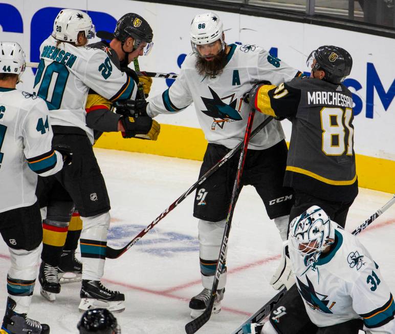 San Jose Sharks defenseman Brent Burns (88, center) begins to fight with Vegas Golden Knights c ...