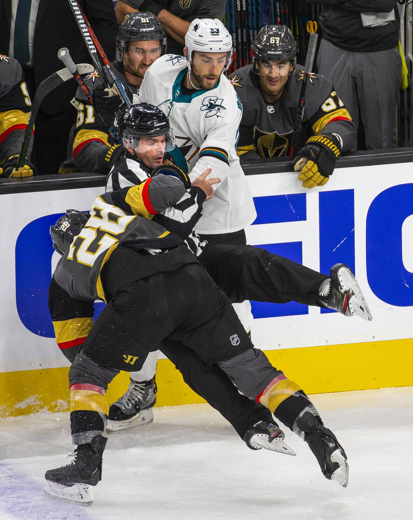 Vegas Golden Knights left wing William Carrier (28, below) and San Jose Sharks right wing Barcl ...