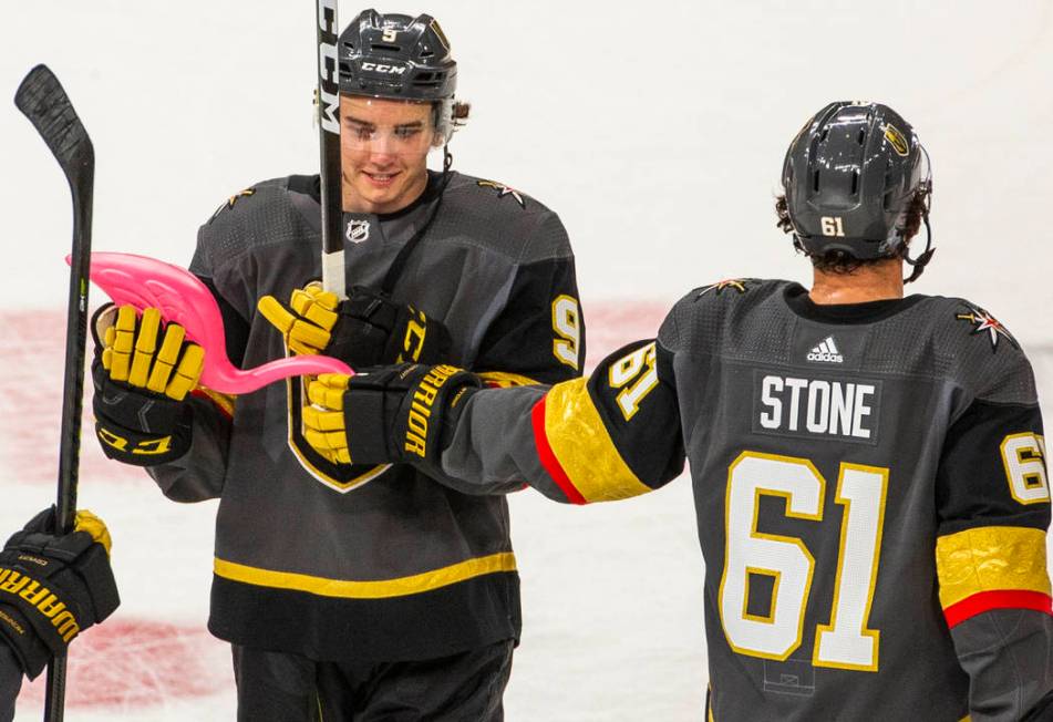 Vegas Golden Knights center Cody Glass (9) receives a pink flamingo from teammate right wing Ma ...