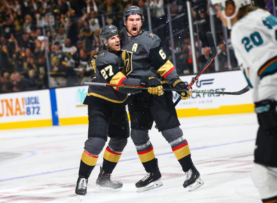 Golden Knights' Mark Stone, right, celebrates his goal with Shea Theodore (27) during the first ...