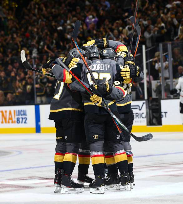 Golden Knights players celebrate after a goal by Mark Stone during the first period of their NH ...