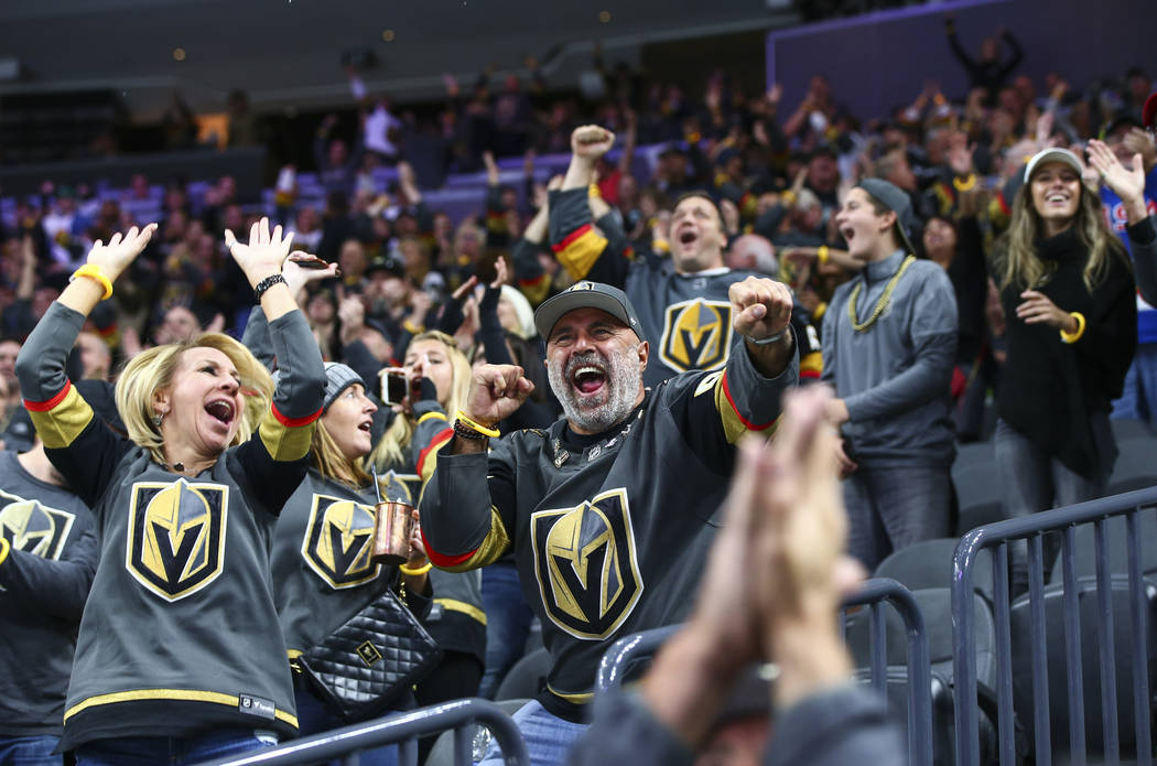 Golden Knights fans celebrate a goal by Cody Glass during the second period of their NHL season ...