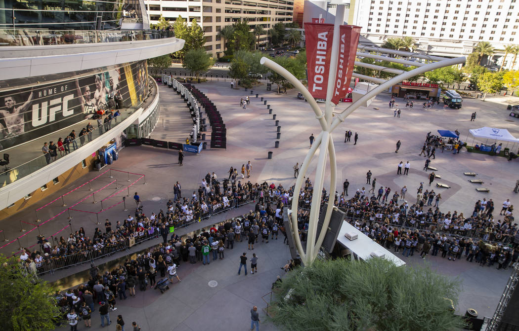 Vegas Golden Knights players walk the gold carpet between fans before their season-opening hock ...