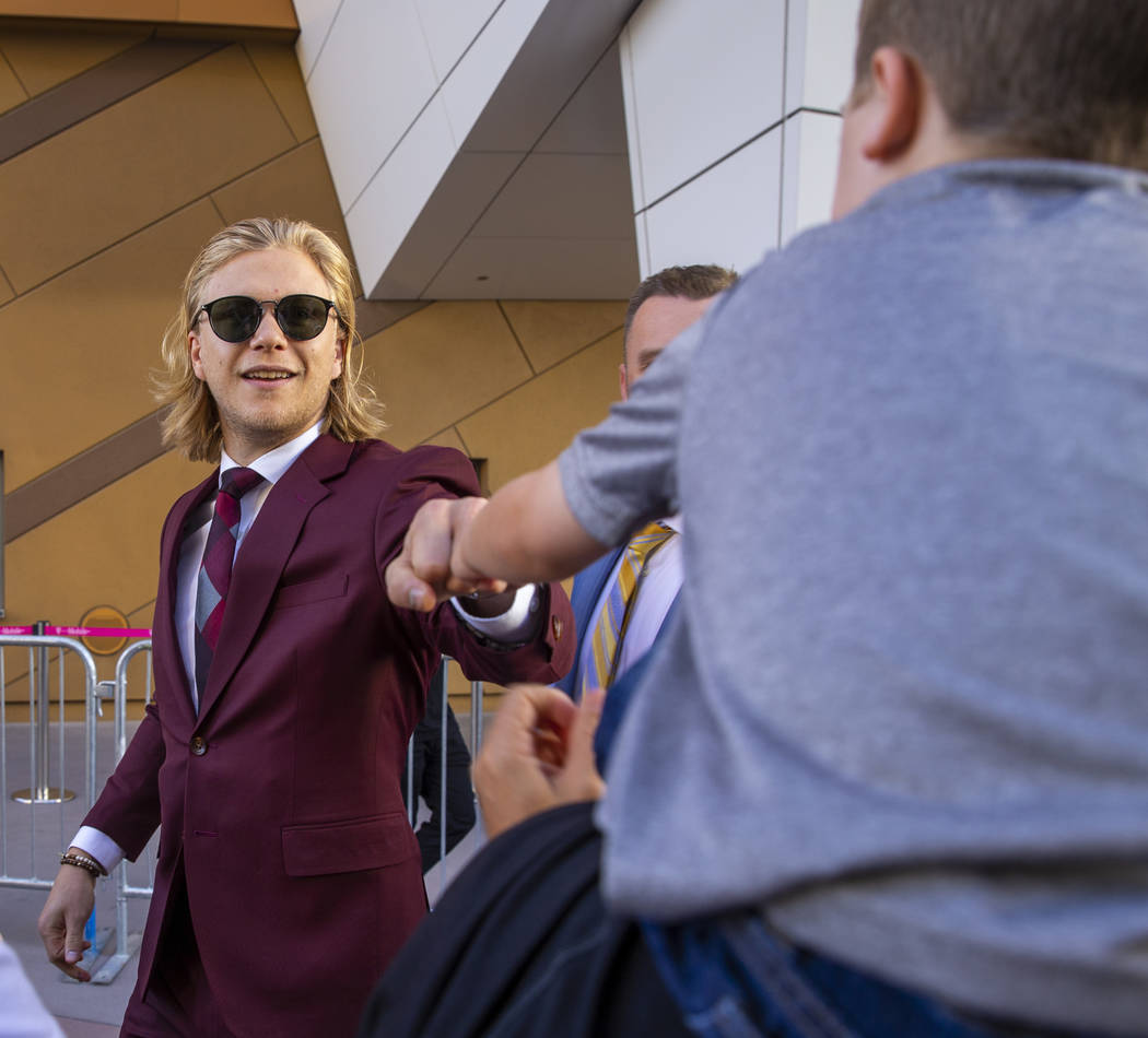 Vegas Golden Knights center William Karlsson gives a fist bump to a young fan while walking the ...