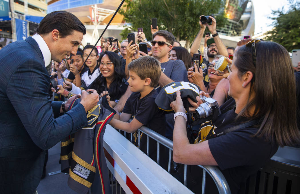 Vegas Golden Knights goaltender Marc-Andre Fleury signs an autograph for Lucas Lanfranchi, 9, w ...