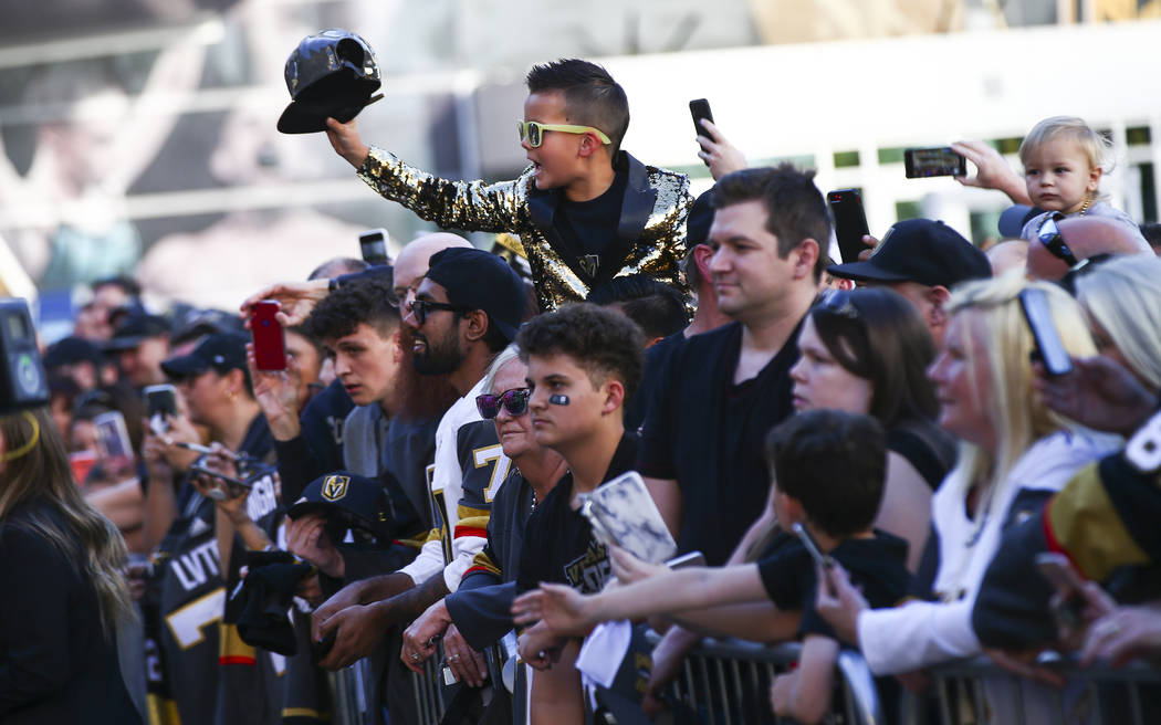 Golden Knights fans try to get autographs on the gold carpet after arriving for the NHL season- ...