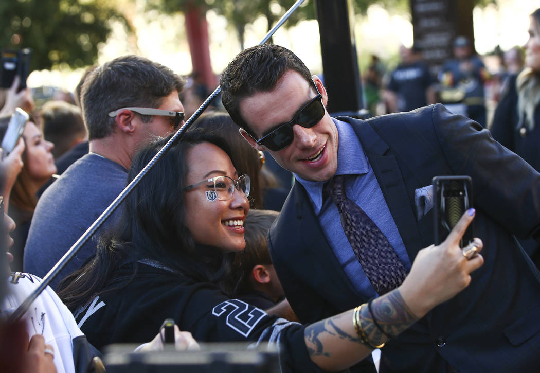 Golden Knights' Reilly Smith poses for pictures on the gold carpet after arriving for the NHL s ...