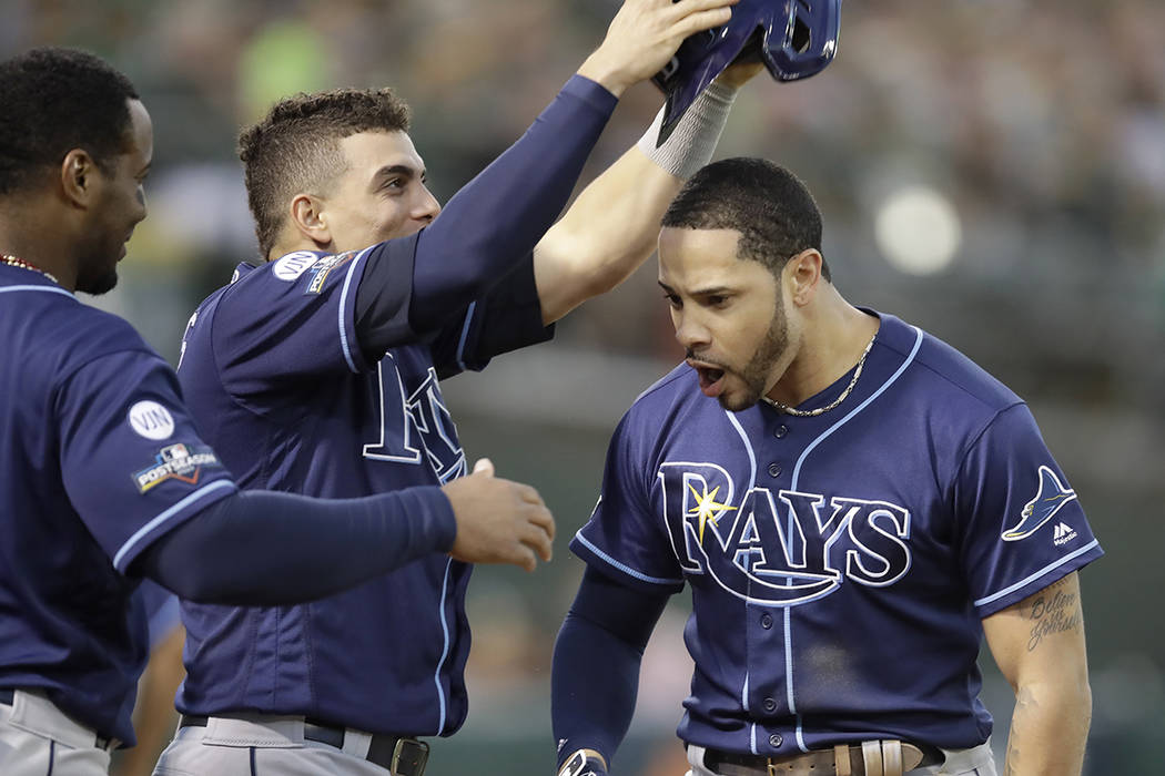 Tampa Bay Rays' Tommy Pham, right, is congratulated by teammates after hitting a solo home run ...