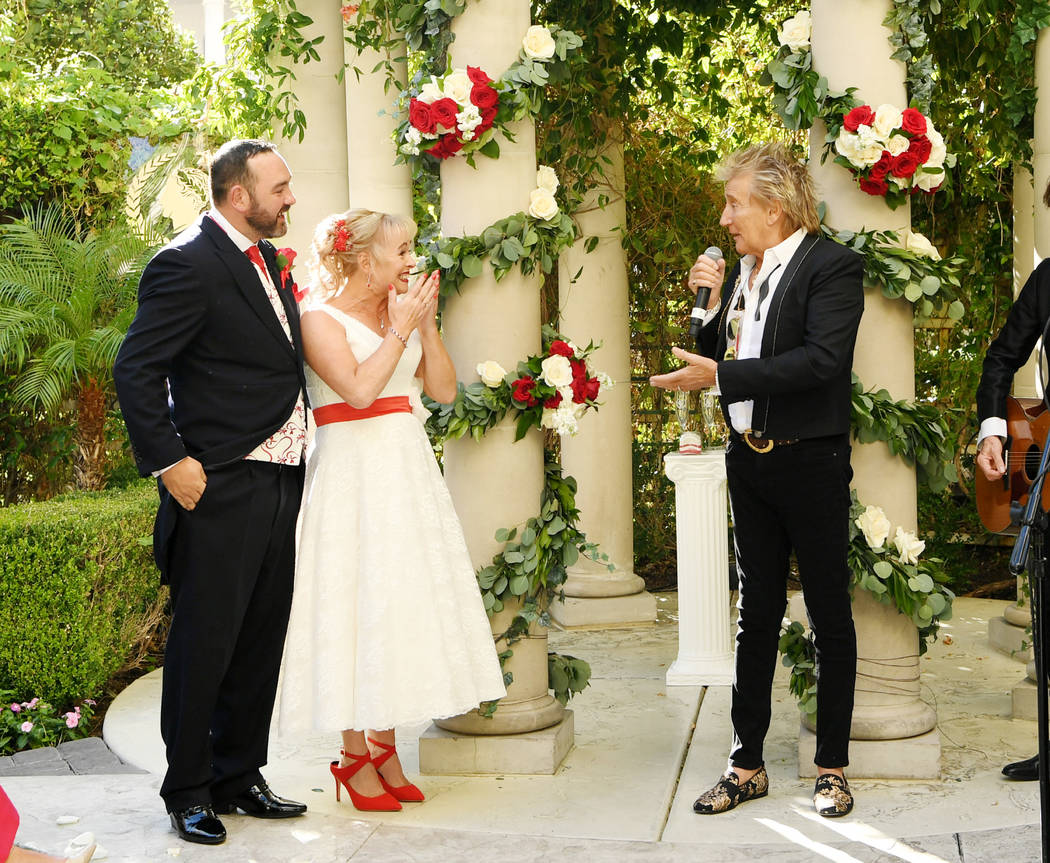 Rock legend Rod Stewart is shown with Sharon Cook and Andrew Aitchison at the couple's wedding ...