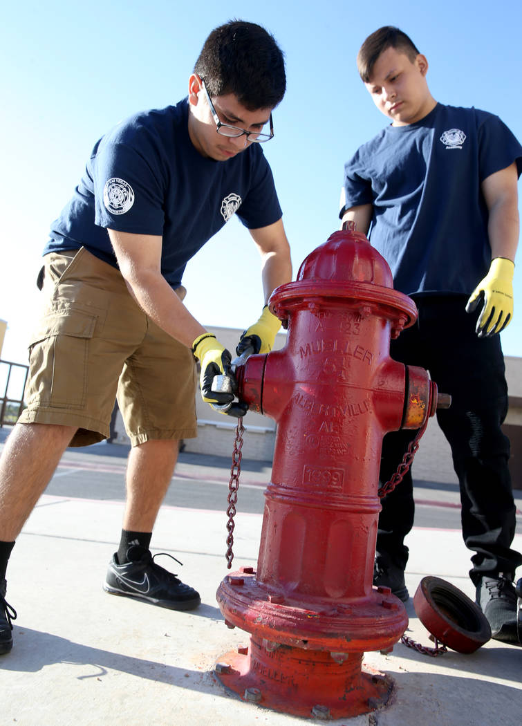 Bonanza High School Fire Science Academy junior Gerardo Bucio, left, and Edgar Linares prepare ...