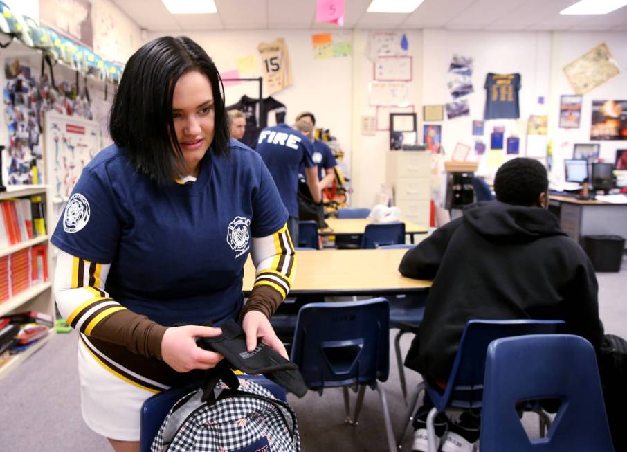 Bonanza High School Fire Science Academy senior Madi Hornbrook prepares to put on her gloves in ...