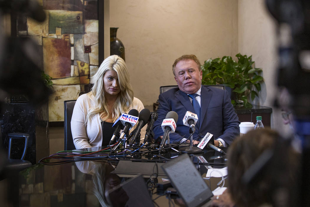 Chelsea Romo, a survivor of the Route 91 mass shooting, left, addresses the media next to Attor ...
