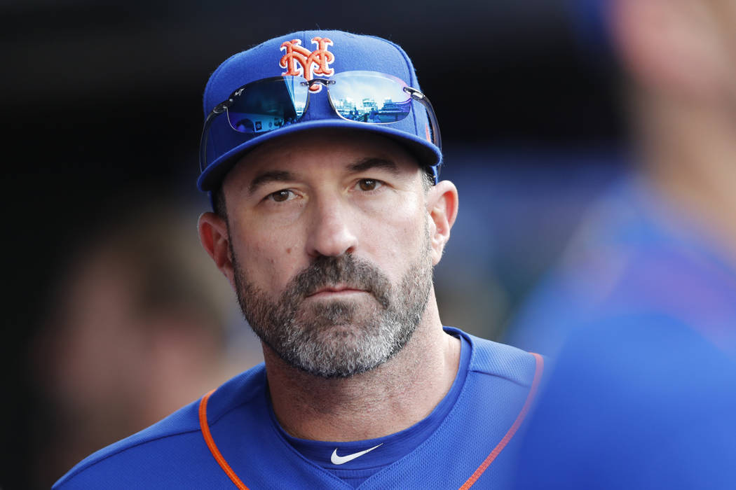 New York Mets manager Mickey Callaway looks out from the dugout during a baseball game against ...