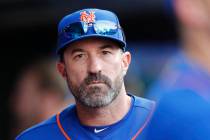 New York Mets manager Mickey Callaway looks out from the dugout during a baseball game against ...