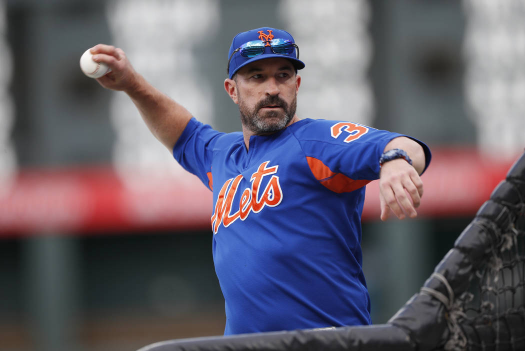 New York Mets manager Mickey Callaway throws batting practice before the team's baseball game a ...