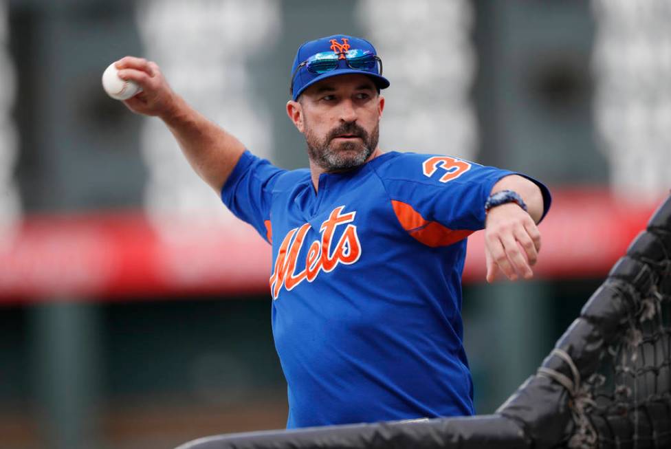 New York Mets manager Mickey Callaway throws batting practice before the team's baseball game a ...