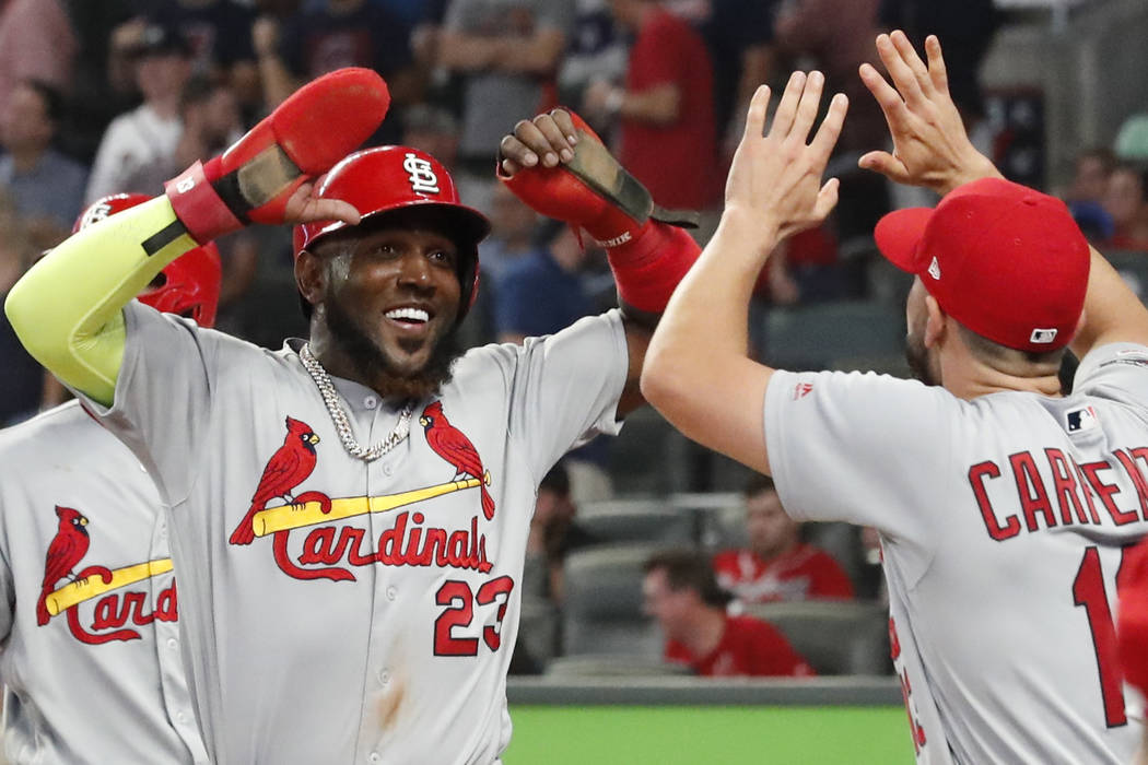 St. Louis Cardinals' Marcell Ozuna (23) celebrates his two-run double against the Atlanta Brave ...