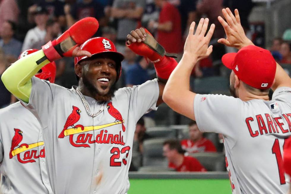 St. Louis Cardinals' Marcell Ozuna (23) celebrates his two-run double against the Atlanta Brave ...