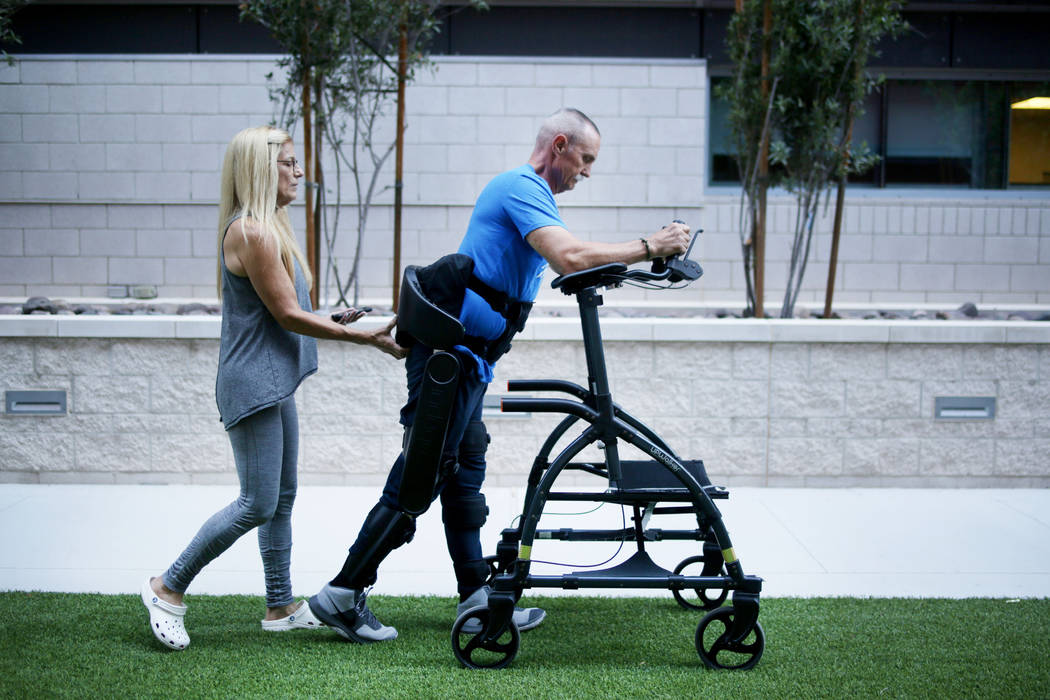 Lisa Christianson, left, helps her husband former Army Sgt.1st Class Green Beret Vietnam vetera ...