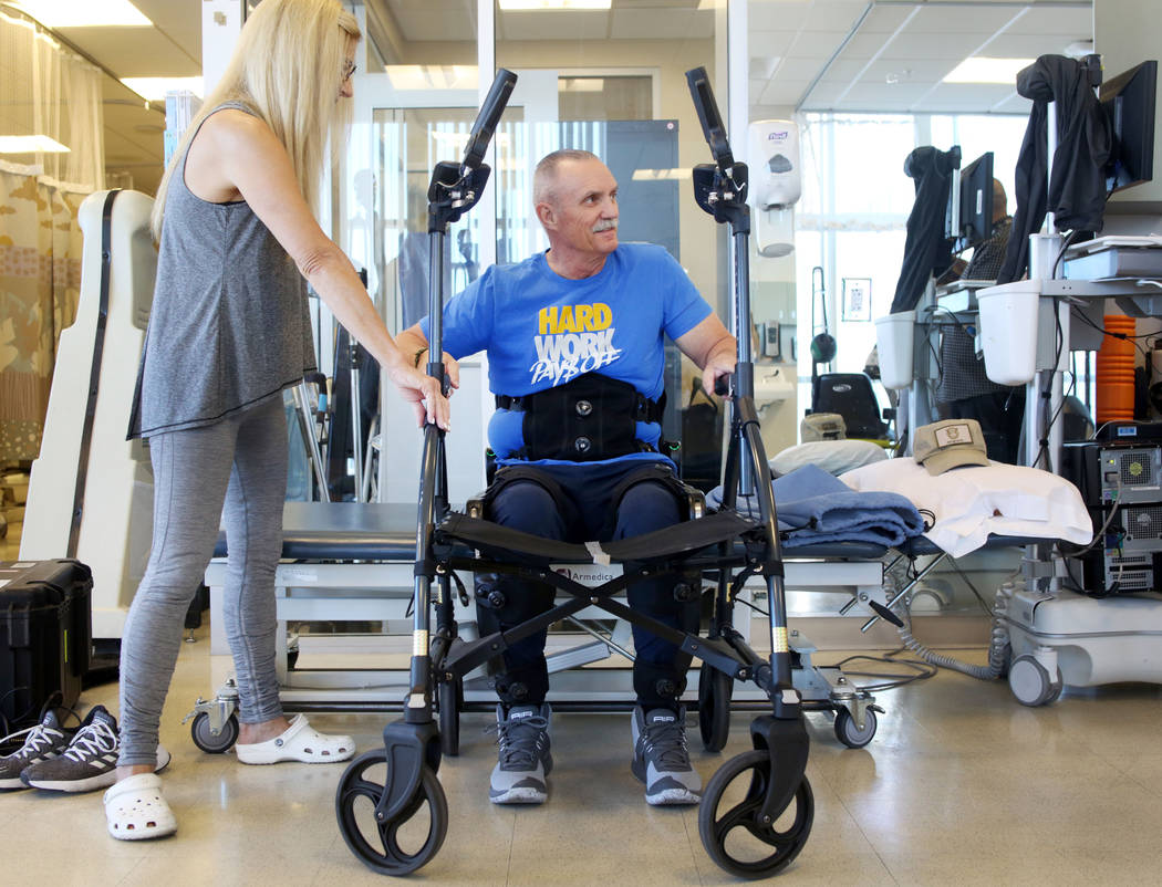 Lisa Christianson, left, helps her husband former Army Sgt.1st Class Green Beret Vietnam vetera ...