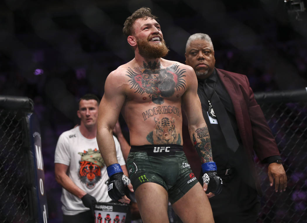 Conor McGregor reacts at the end of a round during his fight against Khabib Nurmagomedov in a l ...