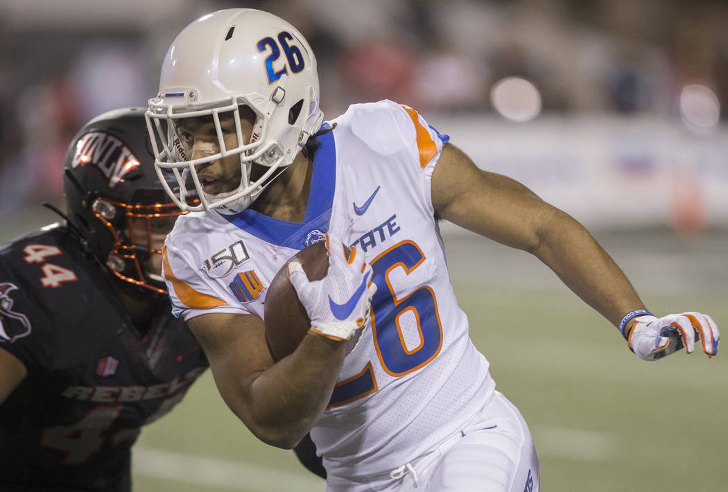 Boise State Broncos cornerback Avery Williams (26) returns a kick past UNLV Rebels linebacker K ...