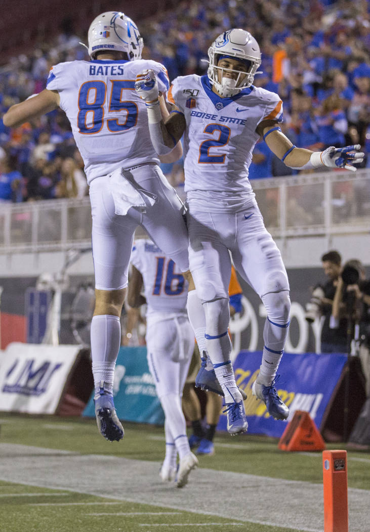 Boise State Broncos wide receiver Khalil Shakir (2) and tight end John Bates (85) celebrate aft ...