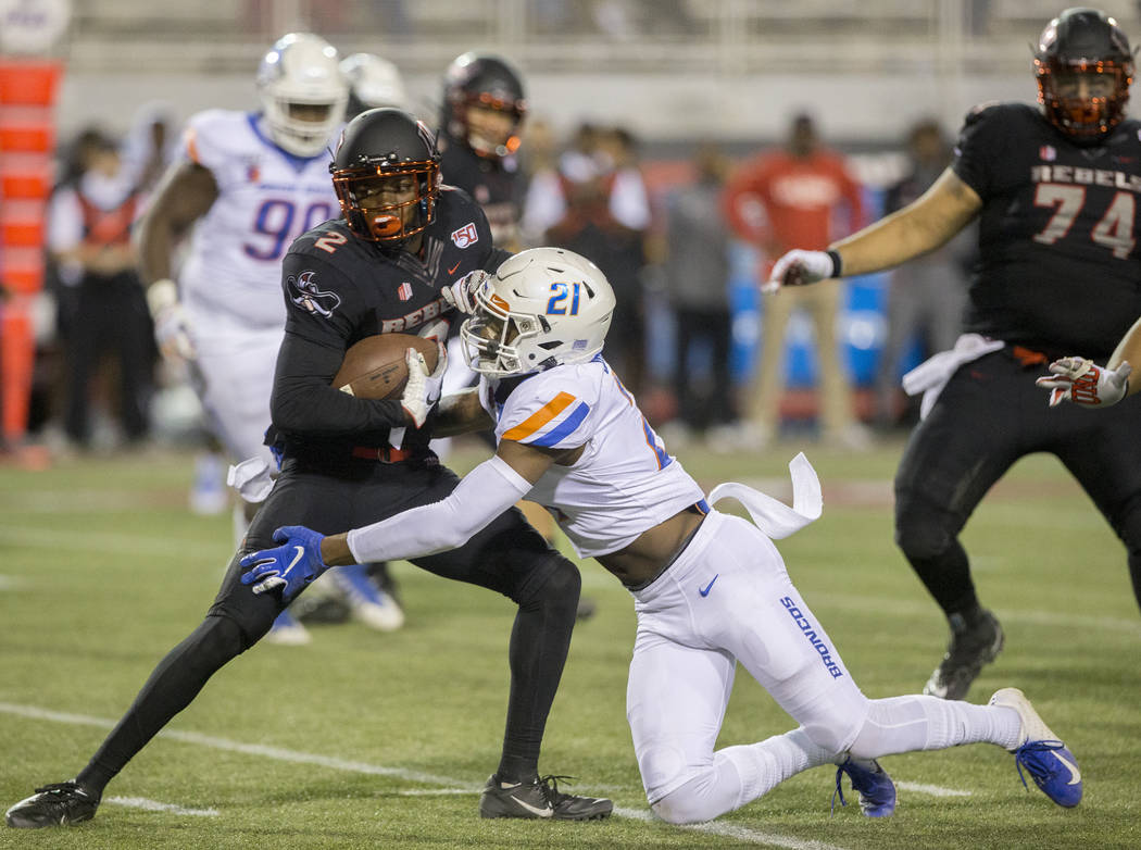 UNLV Rebels wide receiver Mekhi Stevenson (2) fights for extra yardage as Boise State Broncos d ...