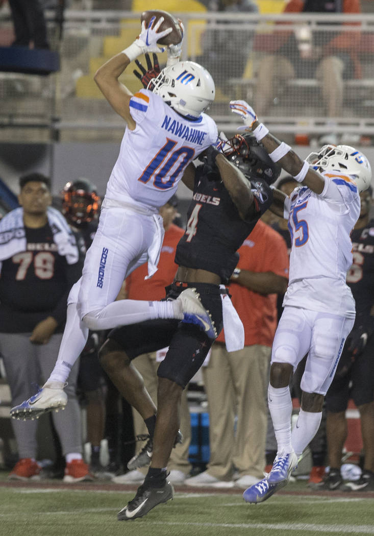 Boise State Broncos safety Kekoa Nawahine (10) makes an interception over UNLV Rebels wide rece ...