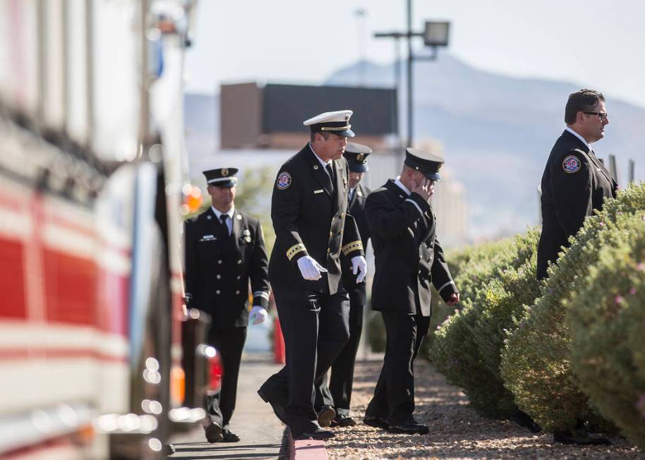 Henderson Fire and Police Department personnel make their way into Central Church to honor the ...