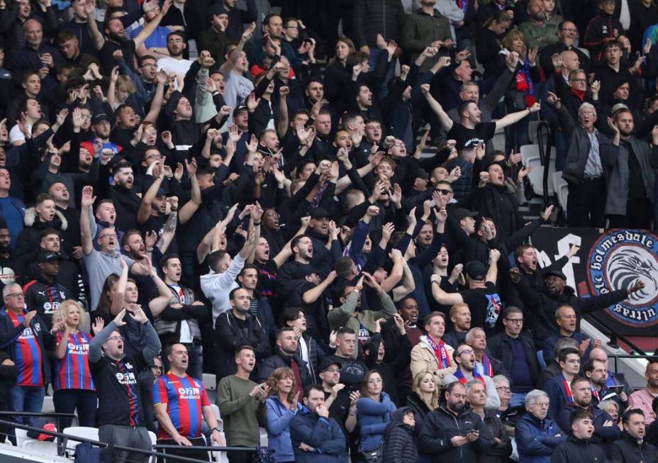 Fans cheer during a soccer match between the West Ham United and the Crystal Palace during the ...