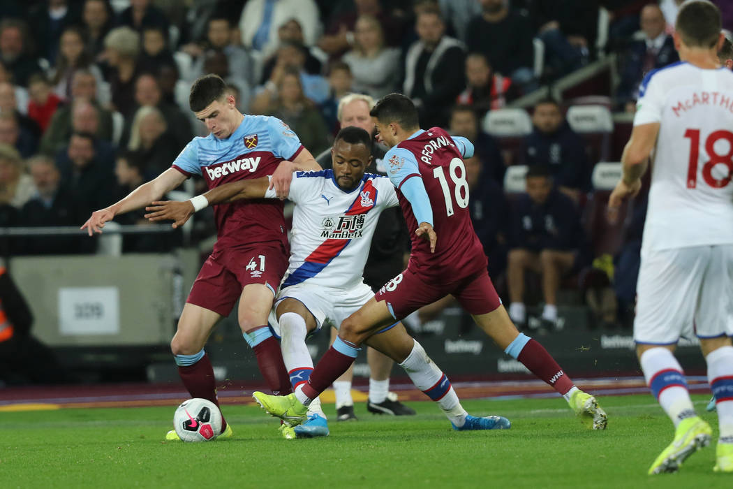 Crystal Palace forward Jordan Ayew (9) tries to recover the ball as West Ham United midfielder ...