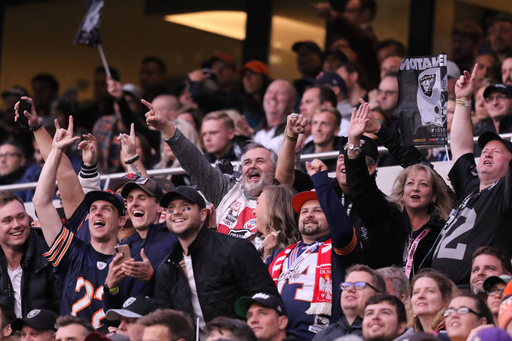Fans cheer during an NFL game between the Oakland Raiders and the Chicago Bears at Tottenham Ho ...