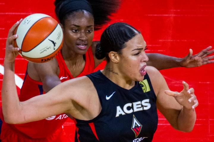 Las Vegas Aces center Liz Cambage (8, front) looks for a pass over Washington Mystics forward L ...