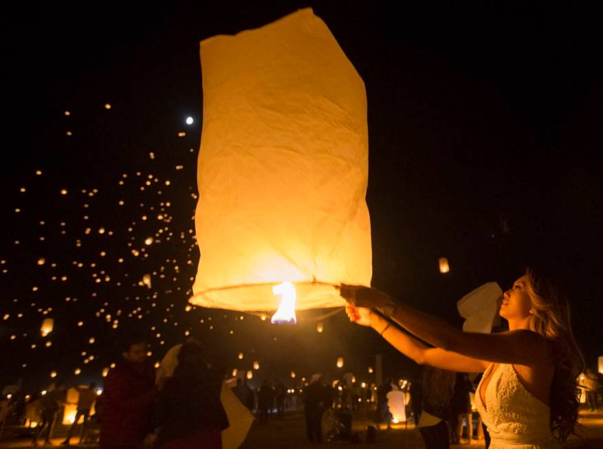 Vi Pham from Seattle releases her lantern during the RiSE festival on Sunday, Oct. 6, 2019, nea ...