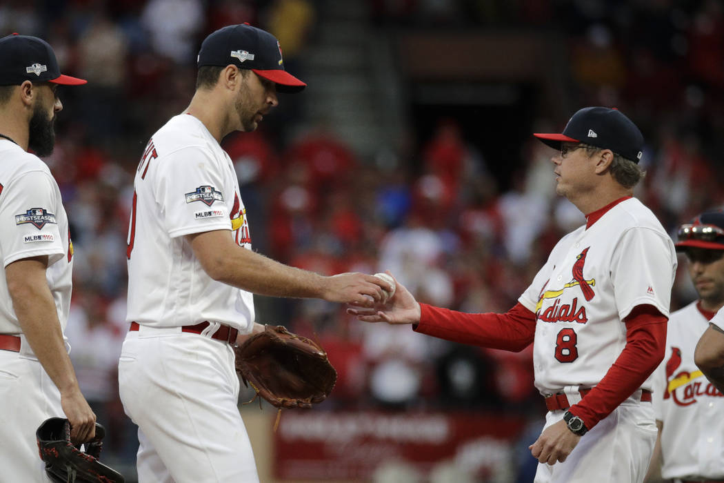 St. Louis Cardinals starting pitcher Adam Wainwright hands the ball to manager Mike Shildt (8) ...