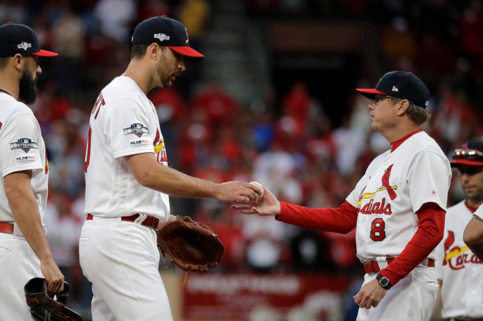 St. Louis Cardinals starting pitcher Adam Wainwright hands the ball to manager Mike Shildt (8) ...