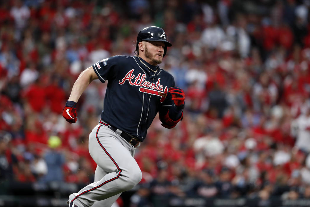 Atlanta Braves' Josh Donaldson runs after hitting a single during the ninth inning in Game 3 of ...