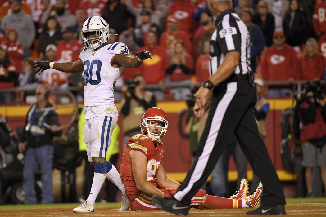 Indianapolis Colts safety George Odum (30) stands over Kansas City Chiefs tight end Travis Kelc ...