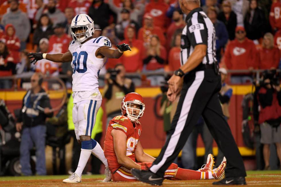 Indianapolis Colts safety George Odum (30) stands over Kansas City Chiefs tight end Travis Kelc ...