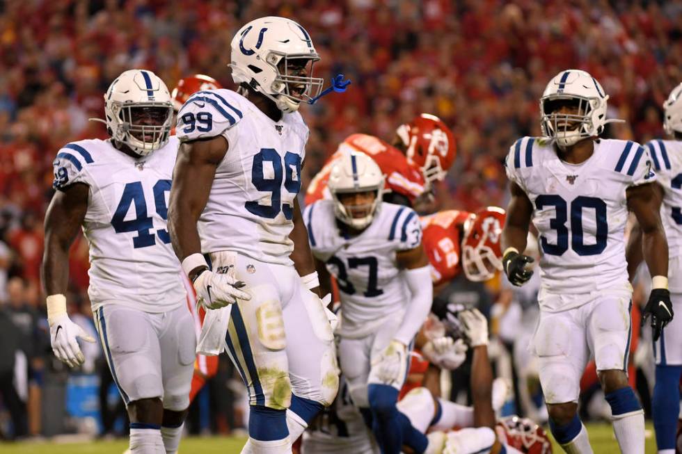 Indianapolis Colts defensive end Justin Houston (99) reacts after tackling Kansas City Chiefs r ...