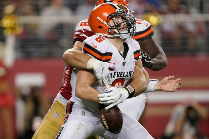 San Francisco 49ers defensive end Nick Bosa, center, sacks and forces a fumble by Cleveland Bro ...